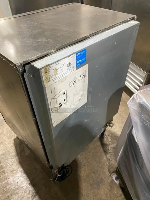 Manitowoc NEO stainless steel ice machine model UYF0140A161B, air-cooled, 115V, on legs, visible use, tags with model details.