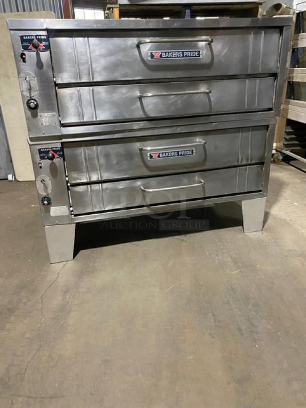 Bakers Pride stainless steel gas-powered double-deck pizza oven, 6-pie capacity, with stones, SN: 5732, on legs.