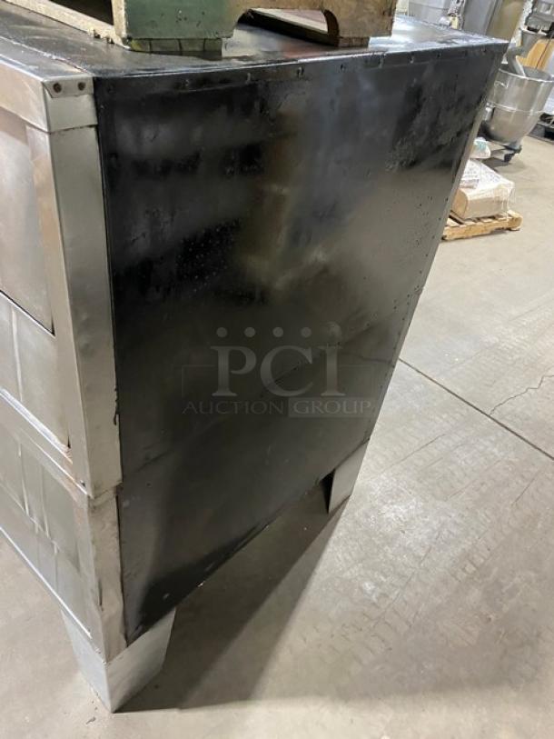 Bakers Pride stainless steel double deck pizza oven on legs; gas-powered; includes stones; SN: 5732; commercial grade.