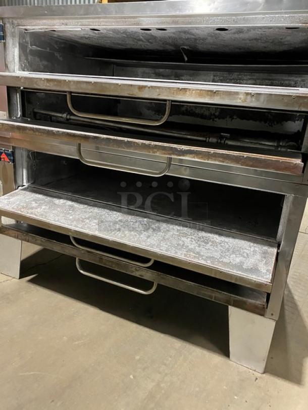 Bakers Pride stainless steel double deck gas pizza oven with stones, SN: 5732, on legs, commercial use, visible wear.