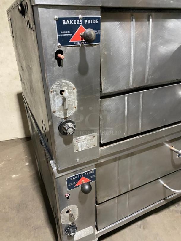 Bakers Pride commercial stainless steel gas double deck pizza oven with stone interiors, model SN: 5732, on legs.