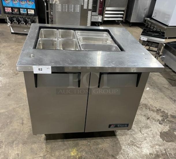 True commercial stainless steel 2-door refrigerated salad prep table, model TSSU-36-12M-B, on casters with steamtable pan.