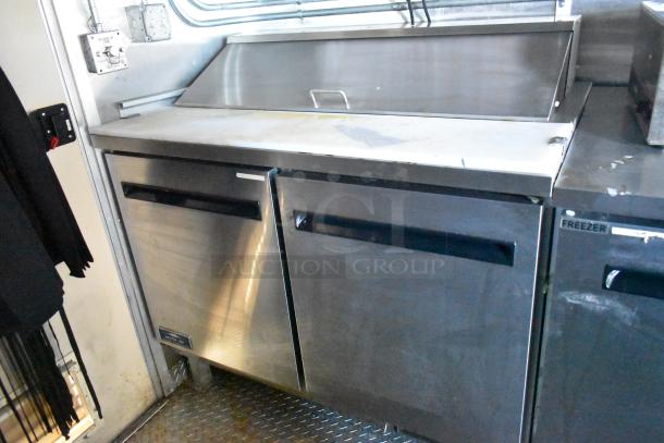 Cruising Kitchens 24' food trailer interior with Arctic Air prep tables, featuring stainless steel finish. Brand new, 2021 model.