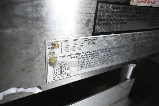 Label on food trailer kitchen equipment, model HDHP-2430G, showing safety instructions and CSA certification mark.