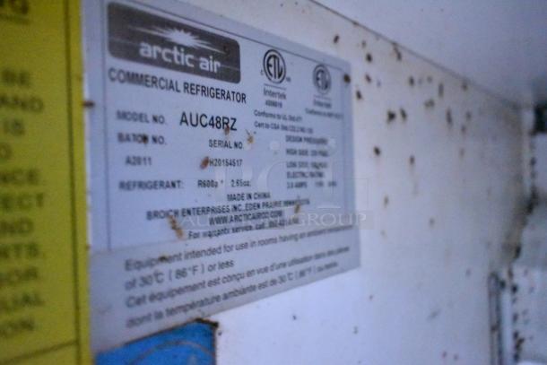 Label on Arctic Air AUC48RZ commercial refrigerator showing model, serial number, and refrigerant details.