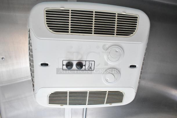 Ceiling-mounted ventilation unit in a Cruising Kitchens food trailer, featuring adjustment knobs and vents.