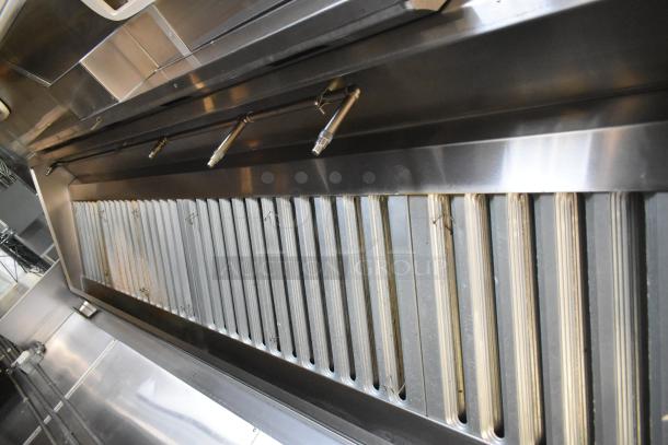 Cruising Kitchens food trailer interior showing stainless steel Pyrochem grease hood system. New condition, 2021 model.