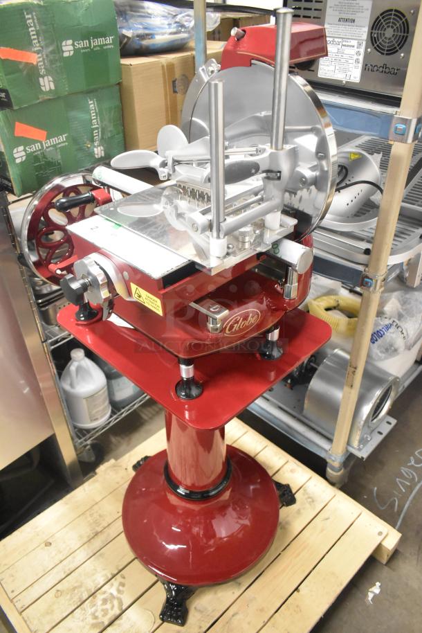 Brand new Globe metal commercial floor-style flywheel meat slicer with blade, red finish, pristine condition, model unspecified.