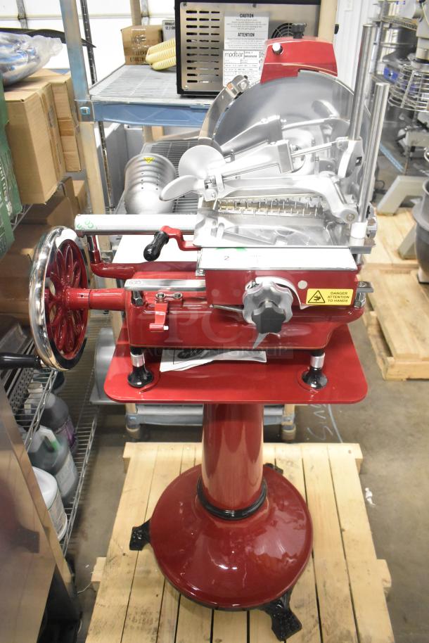 Brand new Globe metal commercial flywheel meat slicer with blade, red pedestal base, safety warnings visible.