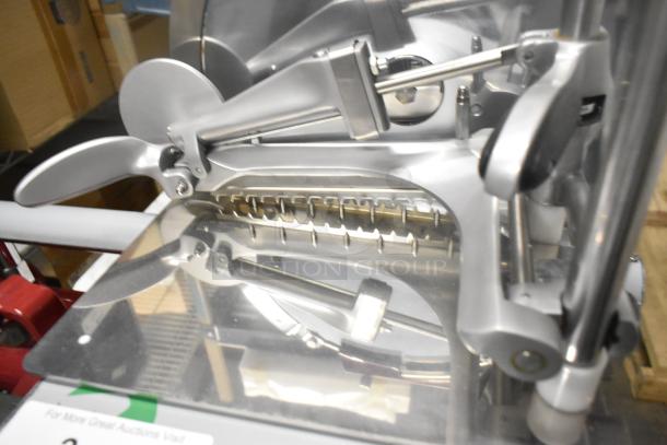 Brand new Globe metal commercial flywheel meat slicer with blade, floor style, featuring stainless steel construction.