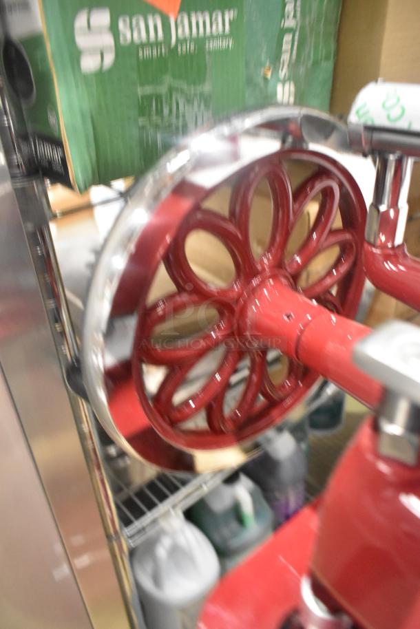 Brand new Globe metal floor-style flywheel meat slicer with blade, shown in glossy red finish, ready for commercial use.