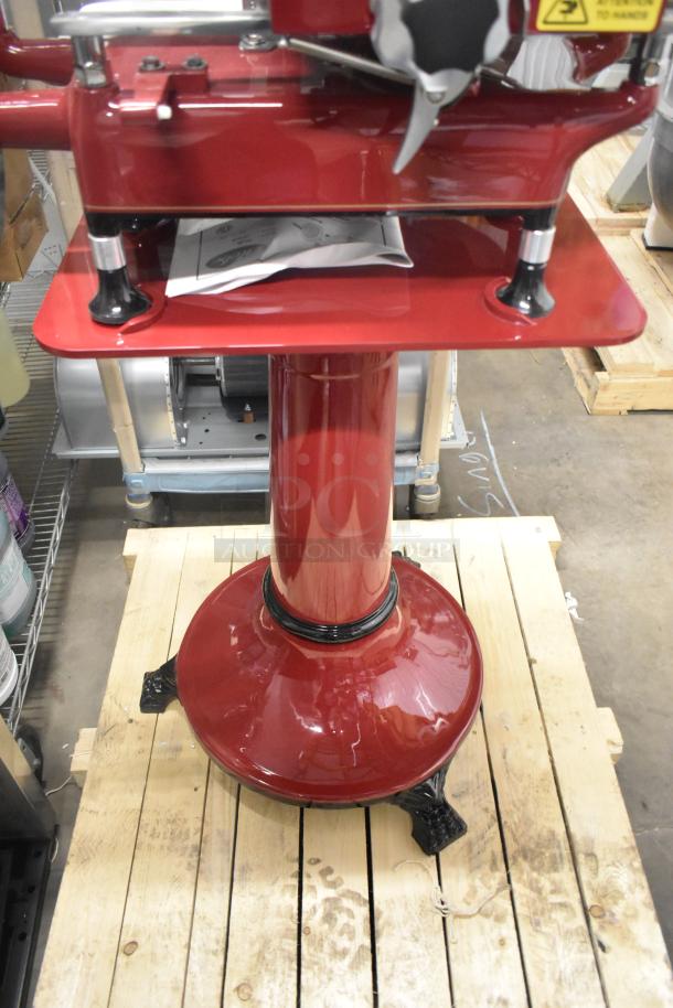 Brand new Globe metal commercial floor-style flywheel meat slicer with blade, red finish, sturdy base, perfect condition.