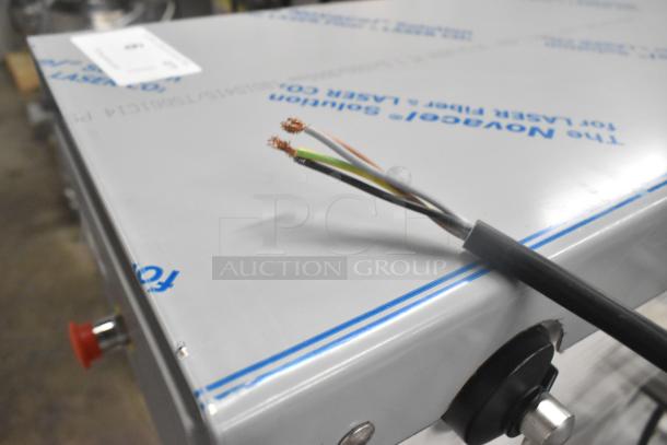 Alt text: Varimixer V60A mixer with exposed wiring on metal surface, showing new condition. Power cord visible. Model details present.