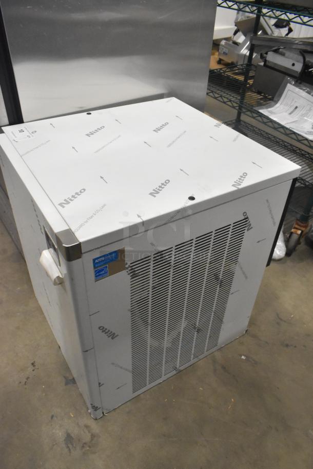 Brand new Manitowoc RFS0650A stainless steel ice head, 220V, 1 phase, minor scratches. Nitto protective wrap visible.