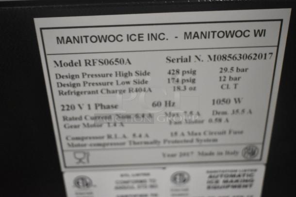 Manitowoc RFS0650A ice head label showing specifications: 220V, 1 Phase, 1050W, R404A refrigerant, made in Italy.