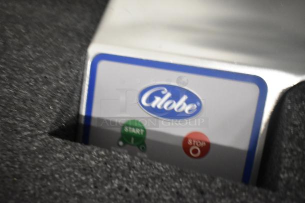 Globe S13 13" stainless steel manual meat slicer with blade sharpener, brand new, features visible start/stop buttons.