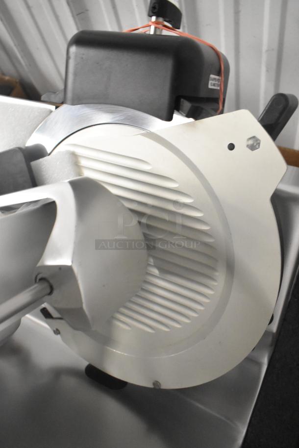 Brand new Globe S13 stainless steel commercial 13" manual meat slicer with built-in blade sharpener.