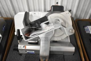 Brand new Globe S13A stainless steel 13" meat slicer with blade sharpener. Includes labels and manuals. 110V, 1 phase.