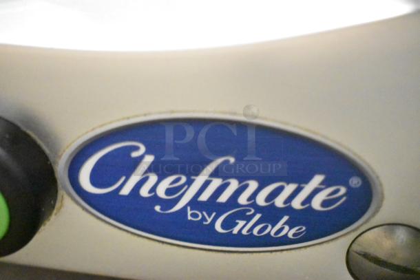 Brand new Globe C10 stainless steel commercial meat slicer with 13" blade, manual operation, and built-in sharpener.