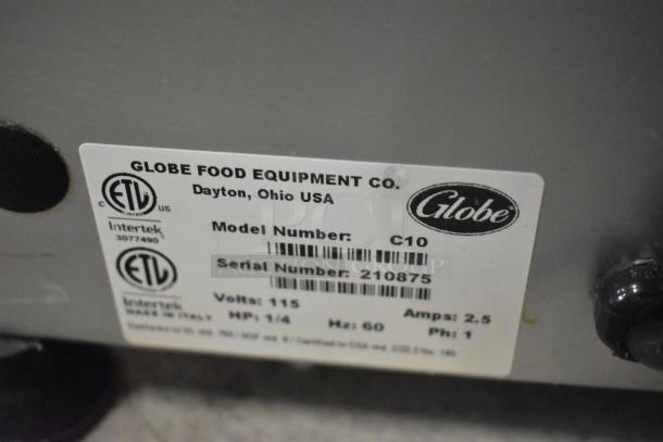 Globe C10 stainless steel meat slicer label, showing model, volts, amps, and serial number. Made in Dayton, Ohio, USA.