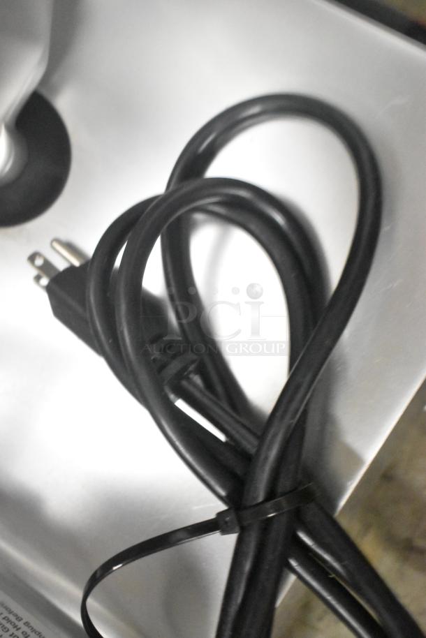 Globe C10 meat slicer power cord on a stainless steel surface, new condition. 110V, 1 Phase.