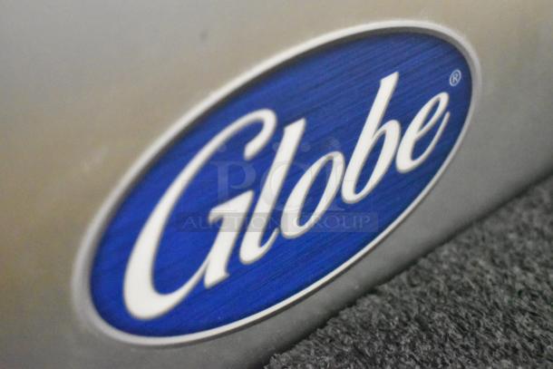Globe logo on a stainless steel surface of the S13-05 commercial meat slicer. Brand new condition.