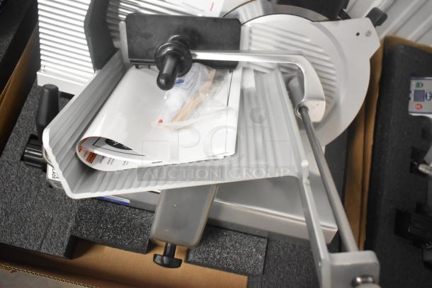 Brand new Globe S13-05 stainless steel commercial meat slicer, 13" with blade sharpener, 220V, 1-phase, manual operation.