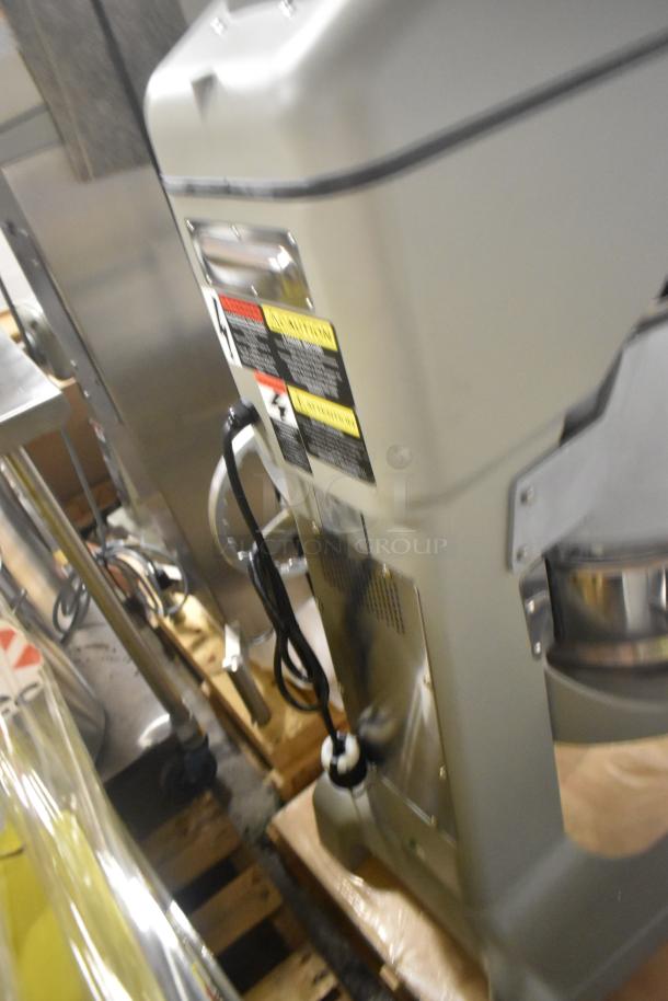 Brand new Globe SPC40 40-quart dough mixer with bowl, guard, whisk, 208V, 3-phase; safety labels visible.