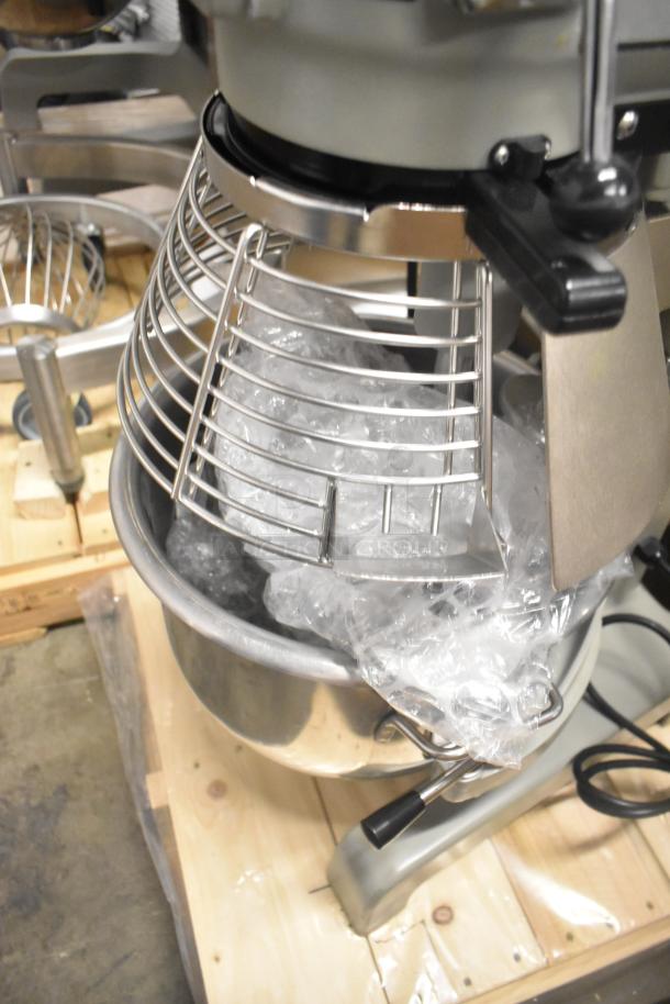 Brand new 2023 Globe SP20 20-quart metal planetary dough mixer with bowl guard. 110 Volts, 1 Phase. Protective packaging visible.