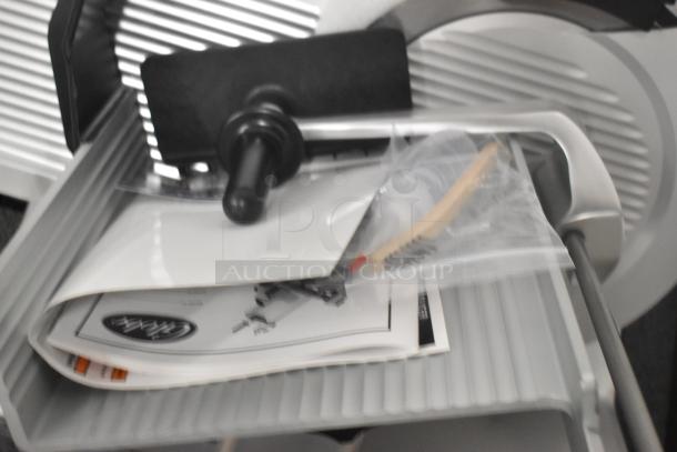 Brand new 2022 Globe S13A-51 stainless steel commercial 13" meat slicer with blade sharpener, manual, and accessories.
