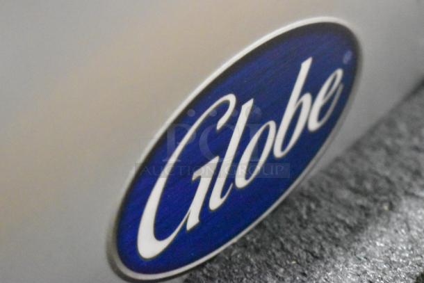 Globe logo on stainless steel surface of a brand new 2022 Globe S13A-51 commercial meat slicer.