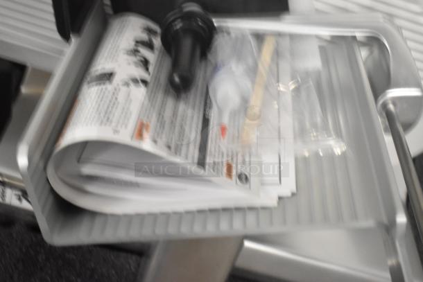 Brand new Globe S13A-24 stainless steel meat slicer, 13" blade, with sharpener and manuals included. 110V, 1 phase.