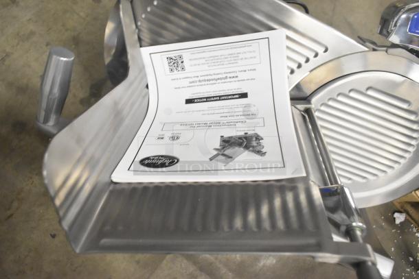 Globe GC512 stainless steel meat slicer, brand new, with blade sharpener. Includes instruction manual, 110 volts, 1 phase.