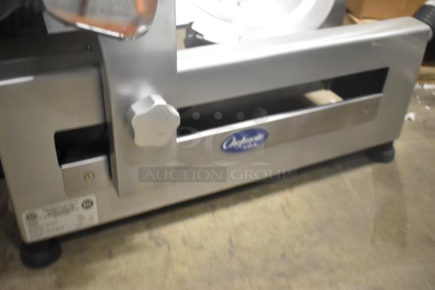 Globe GC512 stainless steel meat slicer, new, with blade sharpener. 110V, medium duty, manual operation, countertop use.