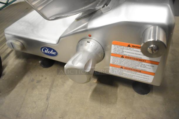 BRAND NEW Globe Stainless Steel Meat Slicer with Blade Sharpener, 110V, 1 Phase. Adjustable settings, safety warnings visible.