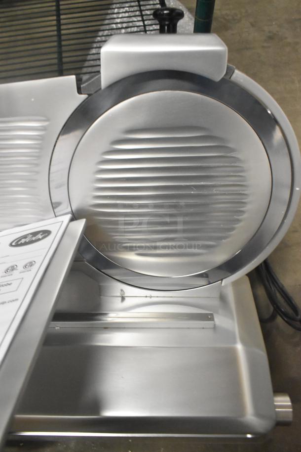 Brand new Globe stainless steel countertop manual meat slicer with blade sharpener, 110V, 1 phase, polished finish.