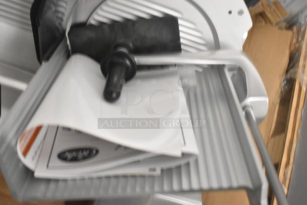 Brand new Globe SG13A stainless steel commercial meat slicer with blade sharpener. Features 13" blade, 110V, 1 phase.