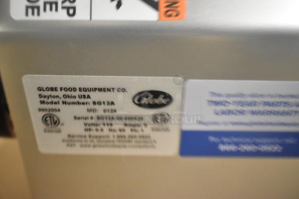 Stainless steel Globe SG13A meat slicer label, showing model and serial number, voltage, and Globe logo.