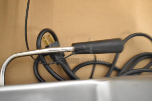 Close-up of the power cord for a Globe SG13A stainless steel commercial meat slicer. 110V plug, new condition.