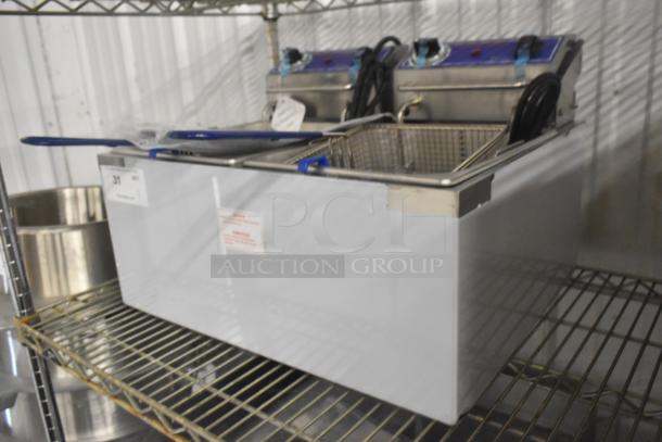 Brand new Globe PF32E stainless steel commercial electric countertop fryer with 2 metal fry baskets, 208/240V, 1 phase.