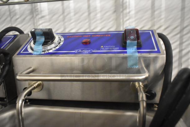 Brand new Globe PF32E stainless steel electric 2-bay fryer with 2 metal baskets, 208/240V, 1 phase. Control panel with caution labels.