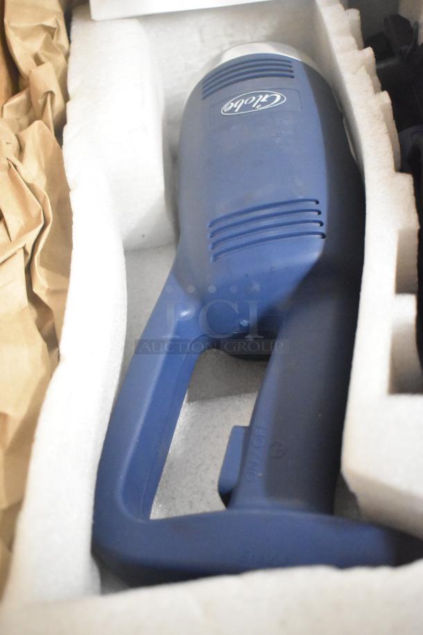 Brand new 2023 Globe GIB750-18 commercial immersion blender, 18-inch, 120V, shown in packaging, blue handle visible.