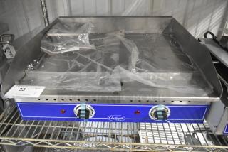 Brand new Globe GEG24 electric griddle; 24" stainless steel, thermostatic controls, commercial countertop model, protective plastic.