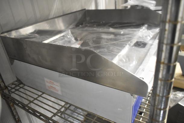 Brand new Globe GEG24 stainless steel commercial electric griddle, 24" countertop model, with thermostatic controls.