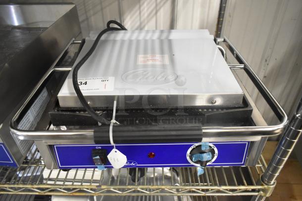 Brand new Globe GPG1410 stainless steel commercial panini press, 120 volts, 1 phase, with control dial and tags displayed.