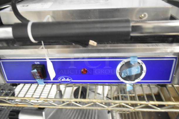 Brand new Globe GPG1410 stainless steel panini press, 120 volts, 1 phase. Features control dial and on/off switch.