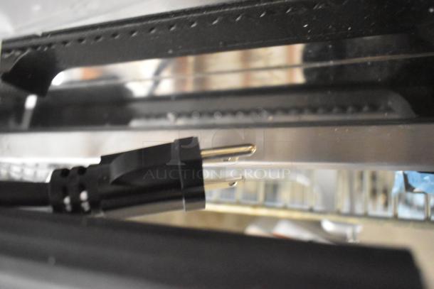 BRAND NEW Globe GPG1410 stainless steel commercial countertop panini press, 120V, 1 phase, with visible plug.