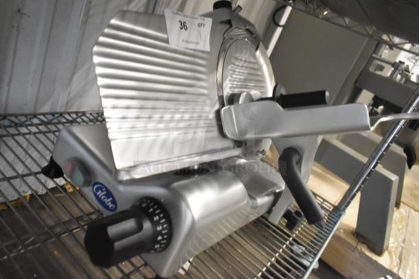 BRAND NEW Globe G10 stainless steel commercial meat slicer with blade sharpener; 120V, 1 phase.