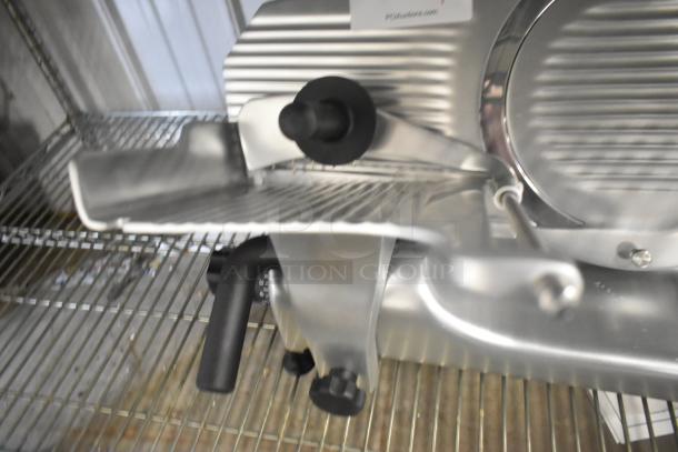 Brand new Globe G10 stainless steel commercial meat slicer with blade sharpener, 120 volts, 1 phase, countertop model.