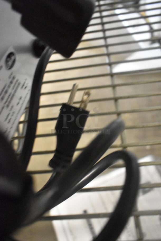 BRAND NEW Globe G10 stainless steel meat slicer, 120V, 1 Phase, includes blade sharpener, seen with power cord.